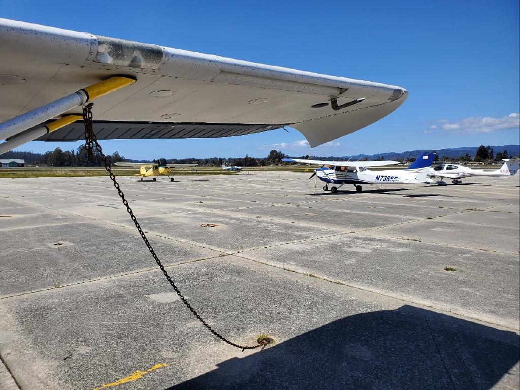 Yellow Cessna 140 in the Distance Stinson 108