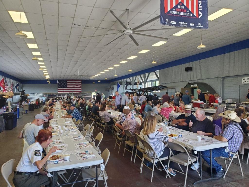 Museum Hall With Tables and 100 People Eating